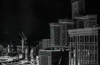Makkah skyline and Clock Tower at night — umrah packages uk
